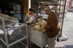 Egyptian men work in a bakery at a market in Cairo.&nbsp;Egypt has been hit hard by record grain prices fueled by the conflict.