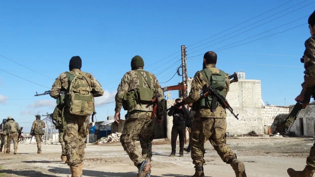 Soldiers walk through Jabal al-Zawiya on March 1, 2020.