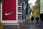 Employees walk on the Nike Inc. headquarters campus in Beaverton, Oregon.