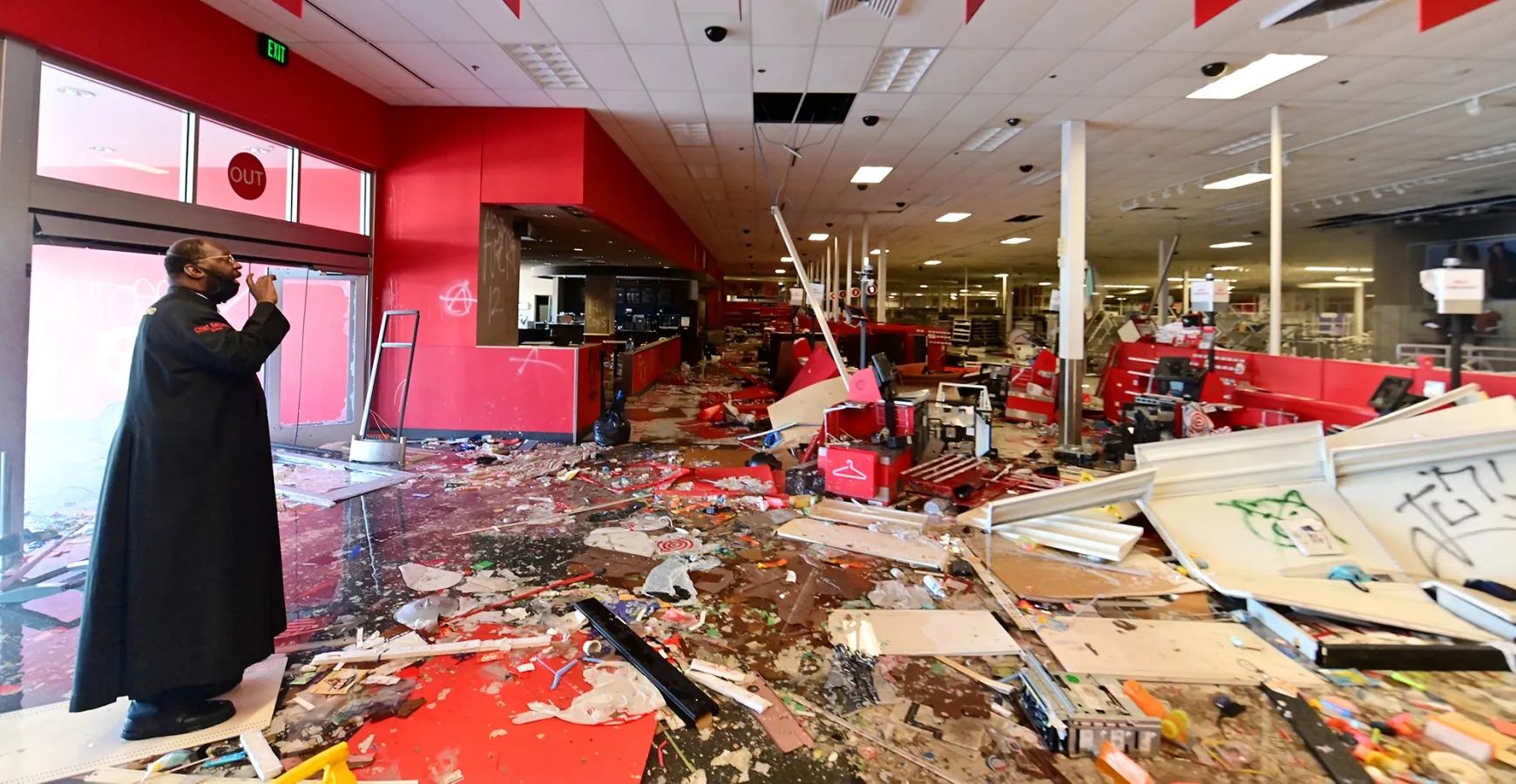 A bishop prays as he surveys the destruction inside a Target store on E. Lake St. in Minneapolis on May 30.