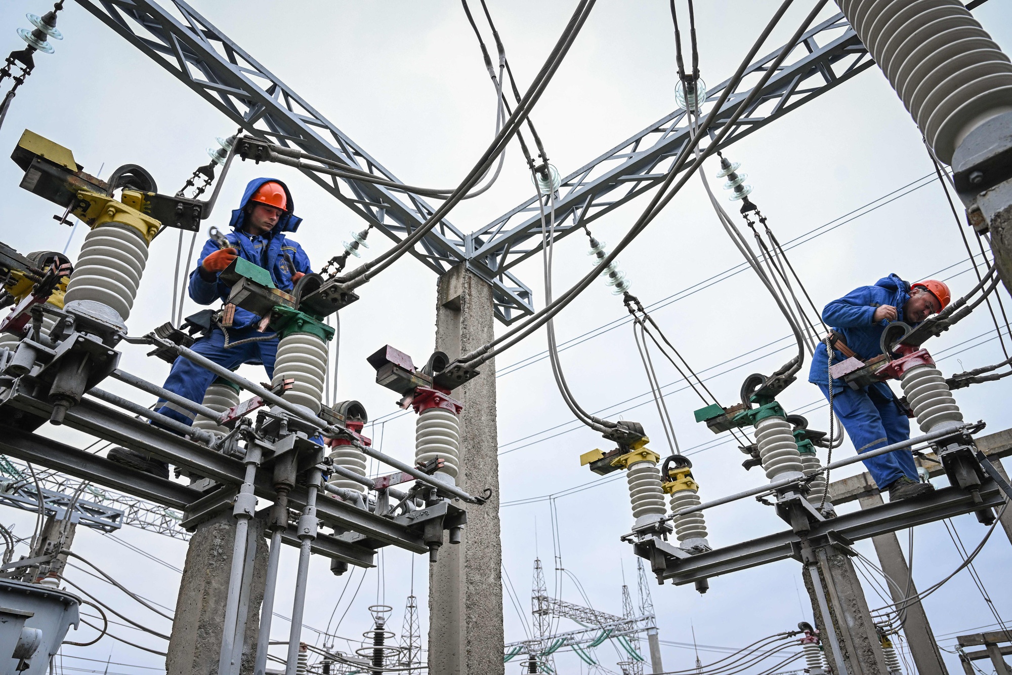 Electricians work on the maintenance of power lines at a power station near Balti, Moldova.