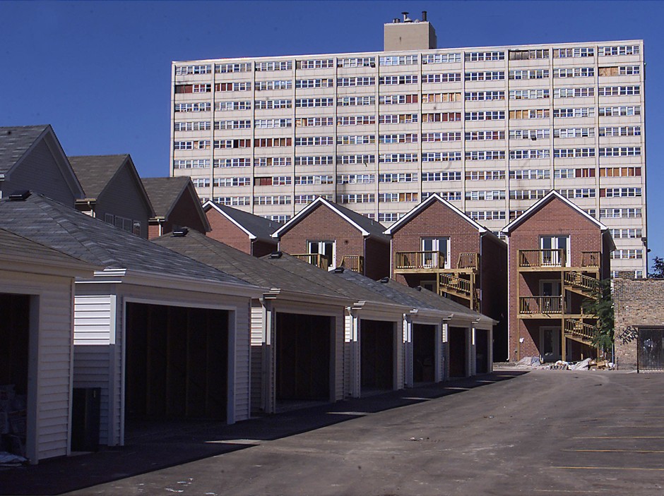The former public-housing high-rise Cabrini Greens stands as a backdrop to mixed-income townhouses in Chicago. (photo taken in 2003)