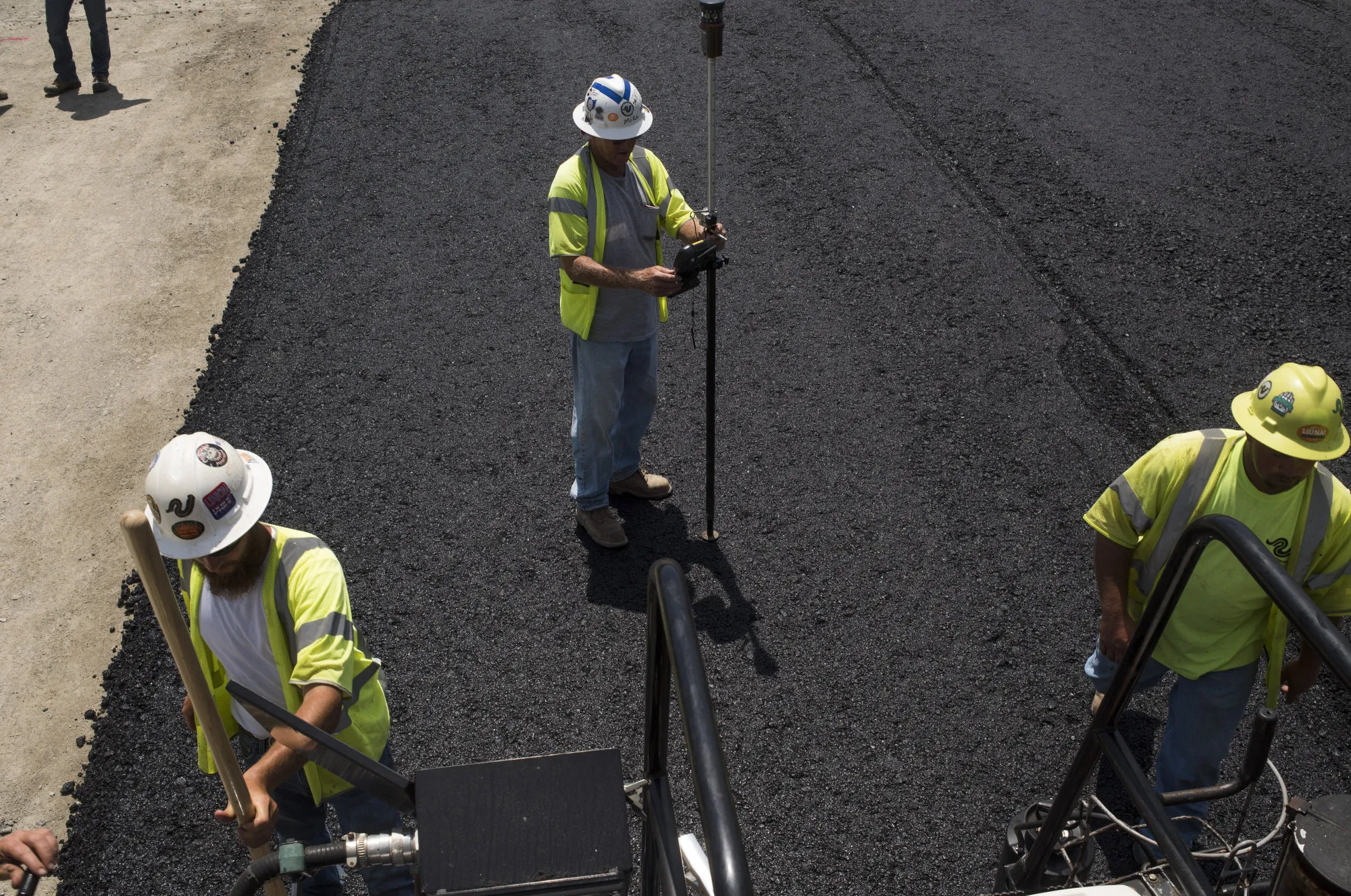 Contractors pave a road near Portsmouth, Ohio, on July 26, 2017.