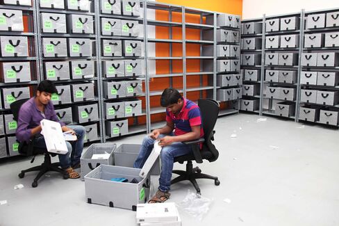 Employees arrange wardrobe into boxes during Myntra's bureau in Bangalore.