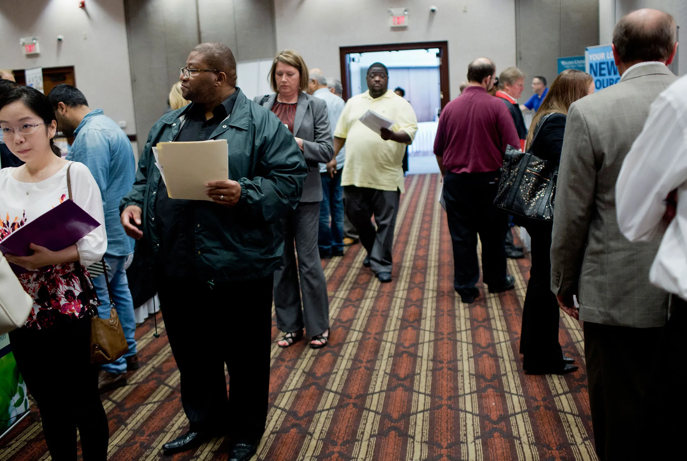 Job seekers move from booth to booth gathering information for various available jobs during a Job Fair Giant career fair in Sterling Heights, Michigan, U.S., on Sept. 30.
