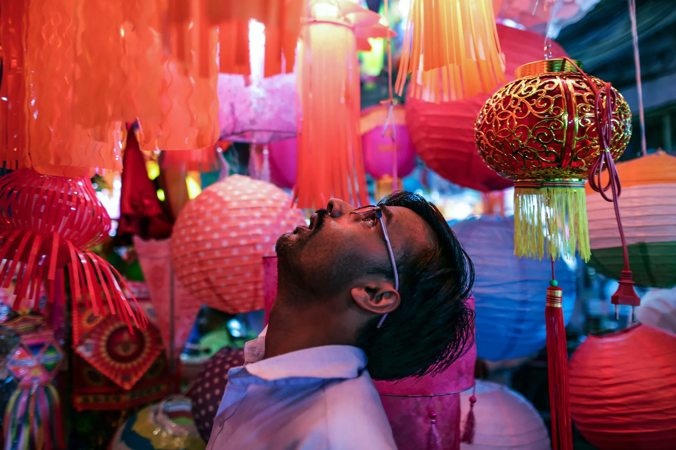 A customer looks at lanterns at a stall during the festival of Dhanteras in the Crawford market area of Mumbai, India, on Monday, Nov. 9, 2015.
