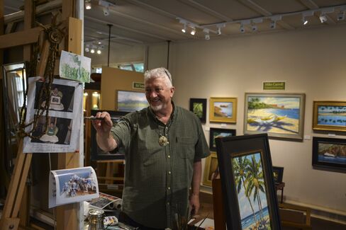 Local artist Mike Carroll working on a painting at his Mike Carroll Gallery in the heart of Lanai City.