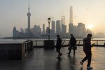 Pedestrians in the Lujiazui Financial District at sunrise in Shanghai, China.