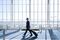 Caucasian businessman pulling luggage in airport