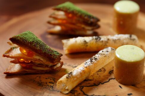 Bites to start the tasting menu at Ko: potato soufflees, lobster paloise, and a millefeuille of salmon roe and matcha powder.