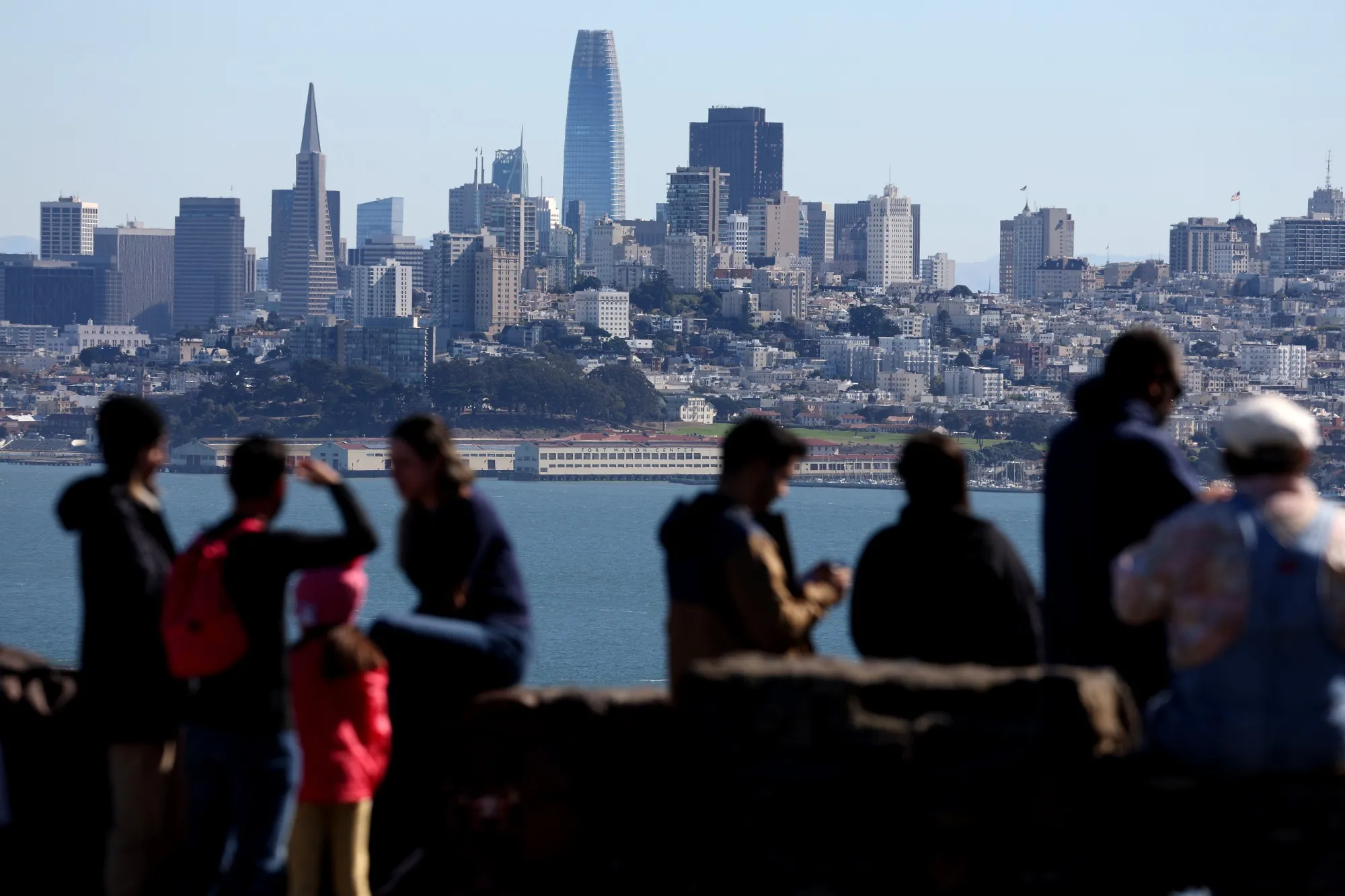 People look at the San Francisco skyline.