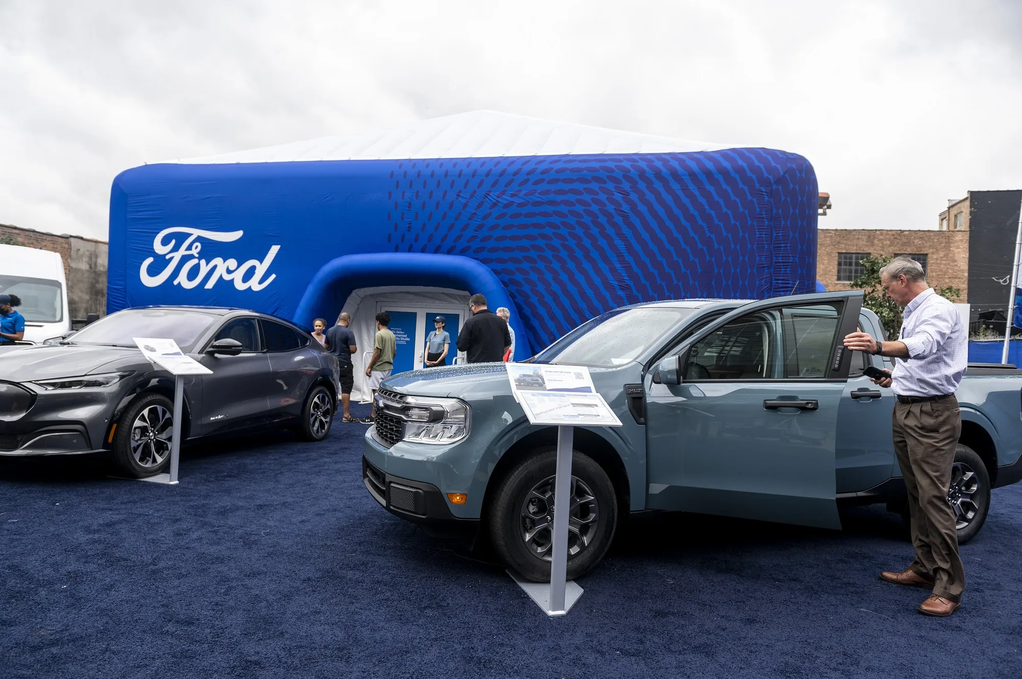 An attendee looks at a 2022 Ford Maverick hybrid pickup truck during the Chicago Auto Show in July.