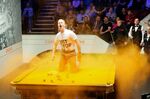 A Just Stop Oil protester throws orange powder over a table during the World Snooker Championships in Sheffield, UK, on April 17.&nbsp;