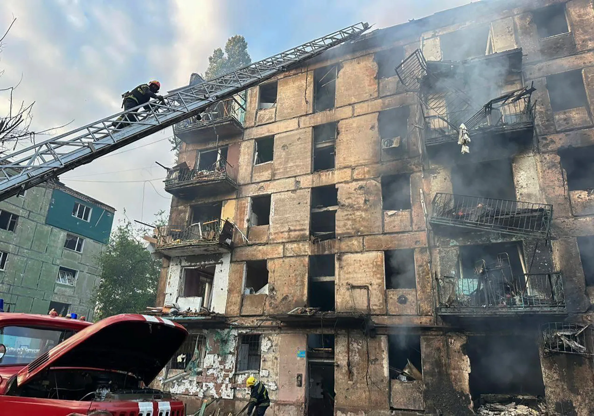 Emergency workers extinguish a fire at an apartment building in Kryvyi Rih, Ukraine, on June 13.