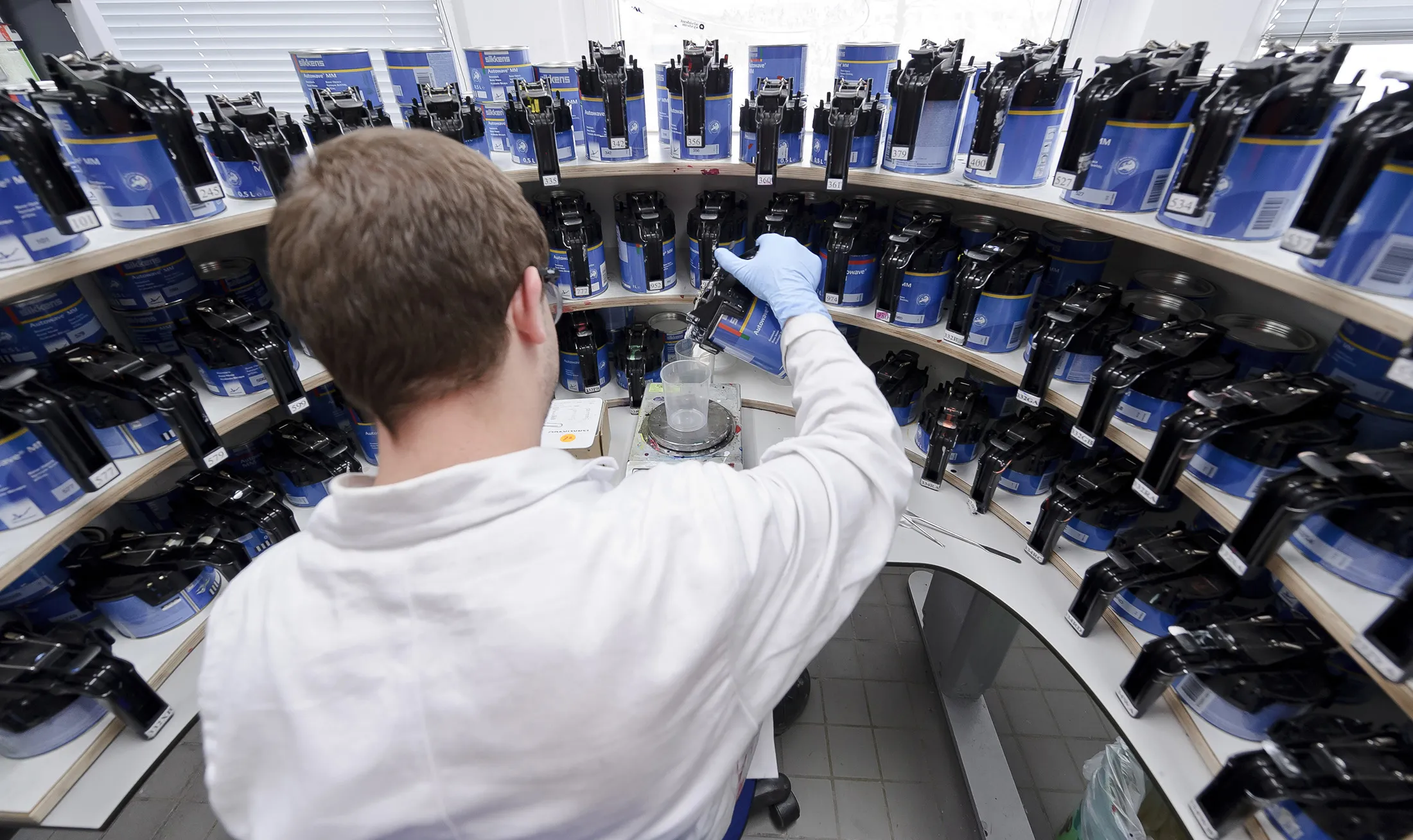 An employee experiments with paint mixtures in the testing lab at the Akzo Nobel NV paint production facility in Sassenheim, Netherlands.
