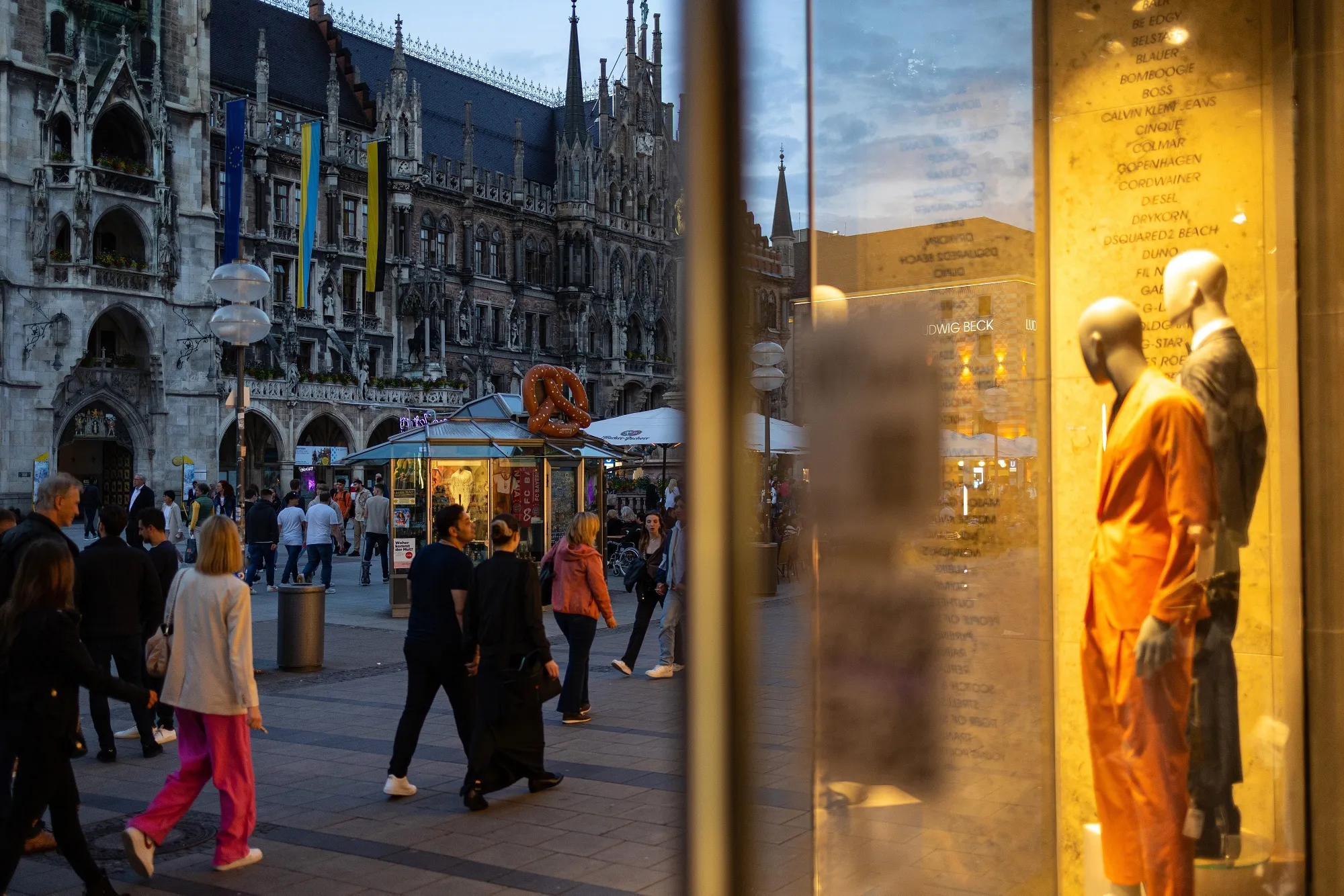 Visitors pass stores and bars at Marienplatz square in Munich, Germany.