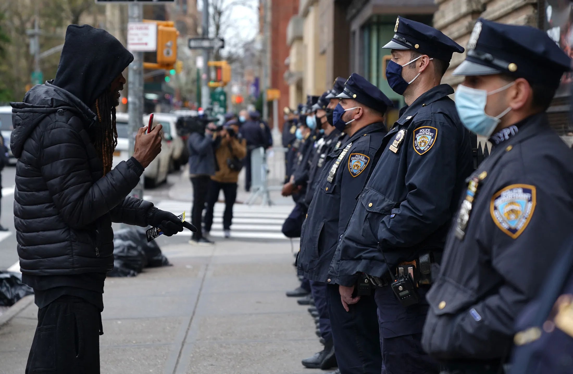 A protestor confronts New York Police Department officers (NYPD) outside Washington Square Park in New York April 12, 2021 during a protest after a suburban Minneapolis police officer fatally shot 20-year-old Daunte Wright during a traffic stop. - A suburb of Minneapolis was under curfew early April 12, 2021 after US police fatally shot a young Black man, sparking protests not far from where a former police officer was on trial for the murder of George Floyd.Hundreds of people gathered outside the police station in Brooklyn Center, northwest of Minneapolis, with police later firing teargas and flash bangs to disperse the crowd, according to an AFP videojournalist. (Photo by TIMOTHY A. CLARY / AFP) (Photo by TIMOTHY A. CLARY/AFP via Getty Images)