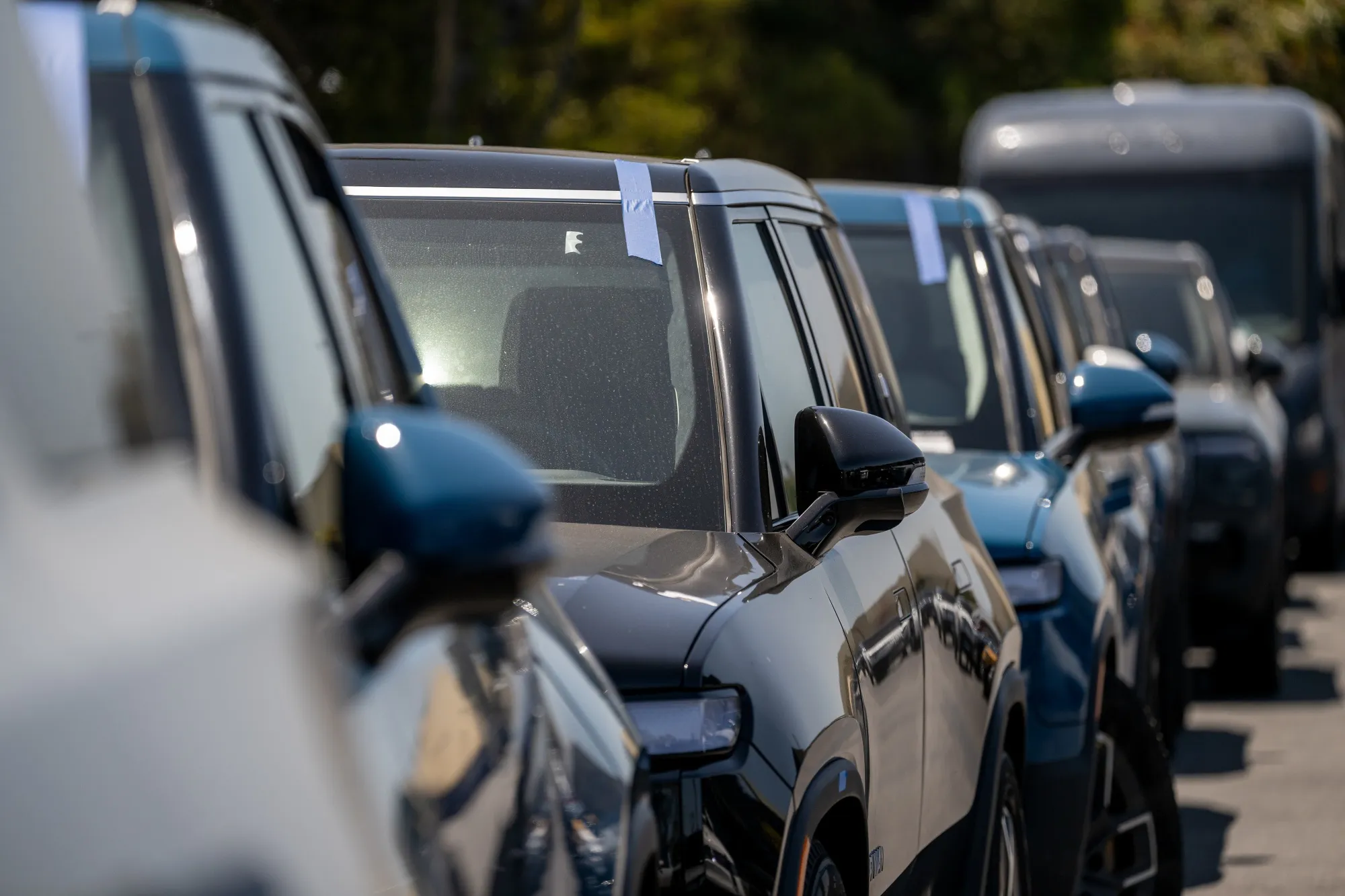 Rivian R1S and R1T electric vehicles (EV) at a dealership and service center in South San Francisco, California.
