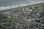 An aerial view of Fairbourne village in Gwynedd in Wales, Wednesday, Oct. 20, 2021. In north Wales, residents in the small coastal village of Fairbourne face being the U.K.'s first &quot;climate refugees.&quot; Authorities say that by 2054, it would no longer be sustainable to keep up flood defenses there because of faster sea level rises and more frequent and extreme storms caused by climate change. (AP Photo/Kirsty Wigglesworth)