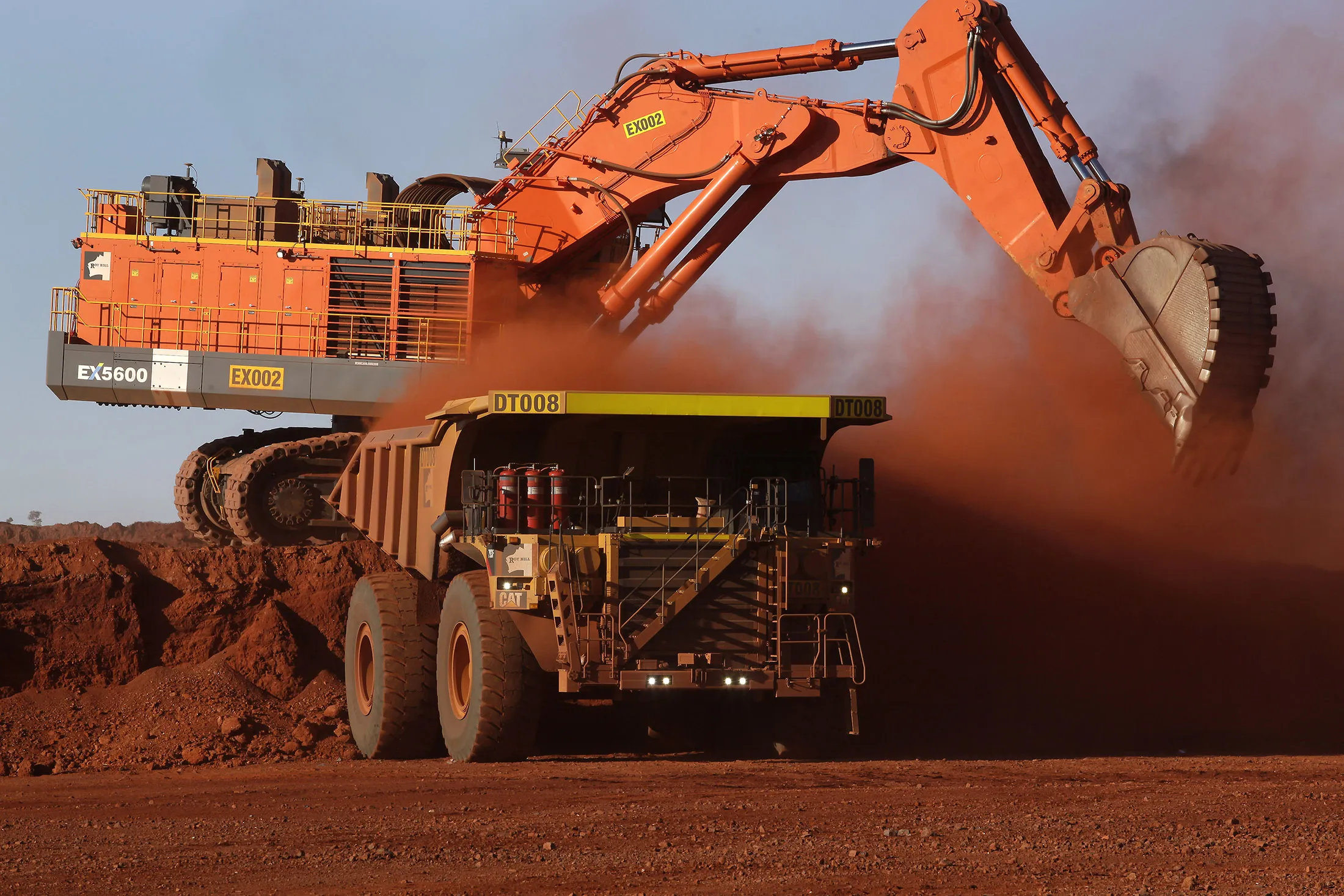 A digger loads ore onto a dump truck at the Delta 2 mine pit in the Pilbara region, Western Australia.
