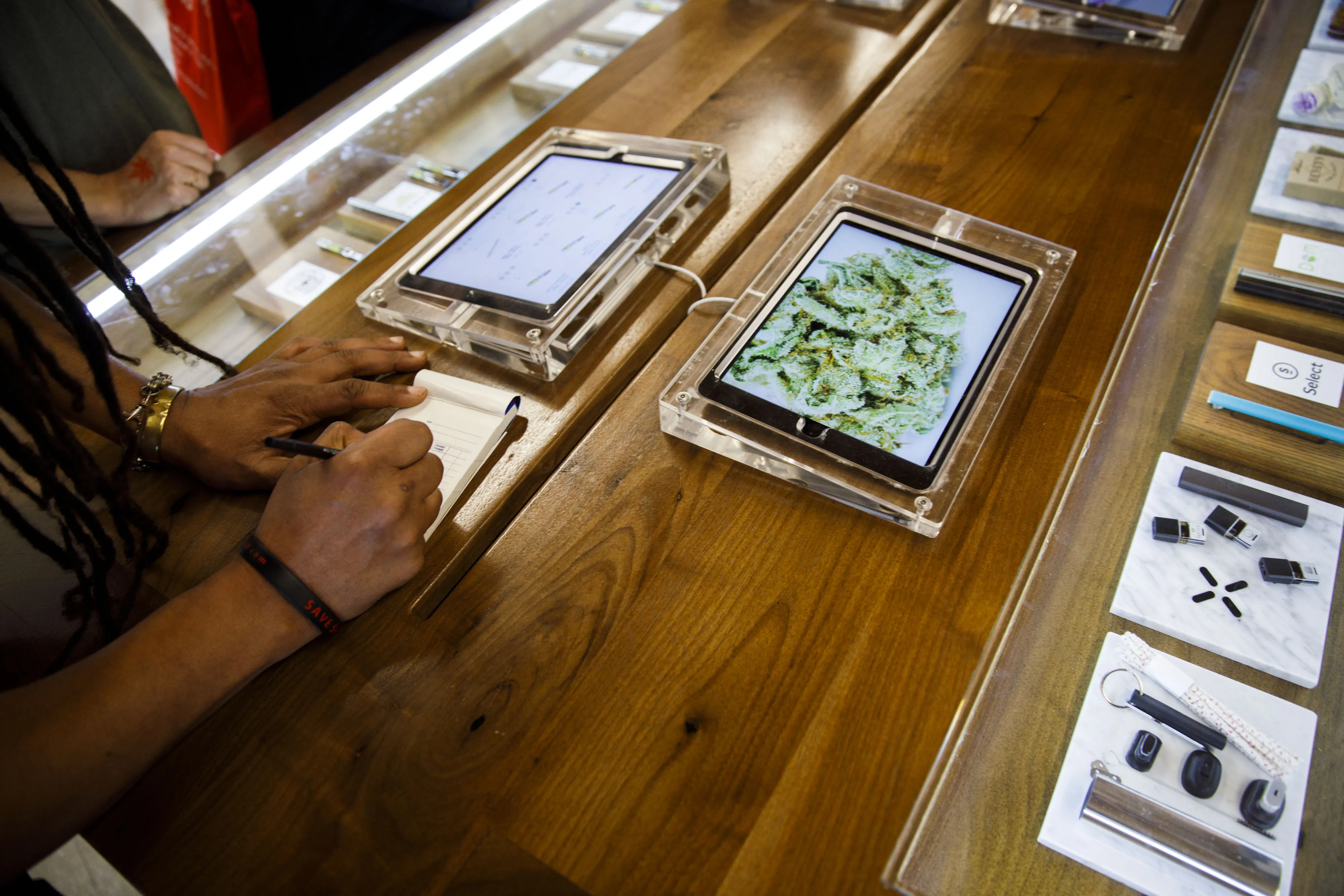 An employee takes a customer’s order at a dispensary in West Hollywood.&nbsp;