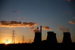 Cooling towers emit vapor at a SSE Plc coal fired power station.