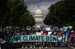 Environmental activists rally near the U.S. Capitol in July.