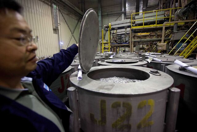 Chen Kerong, director of production at Neo Material Technologies Inc.'s Magnequench Tianjin Co. factory, opens a barrel of annealed neodymium iron boron magnets prior to being crushed into powder in Tianjin, China, on Friday, June 11, 2010.
