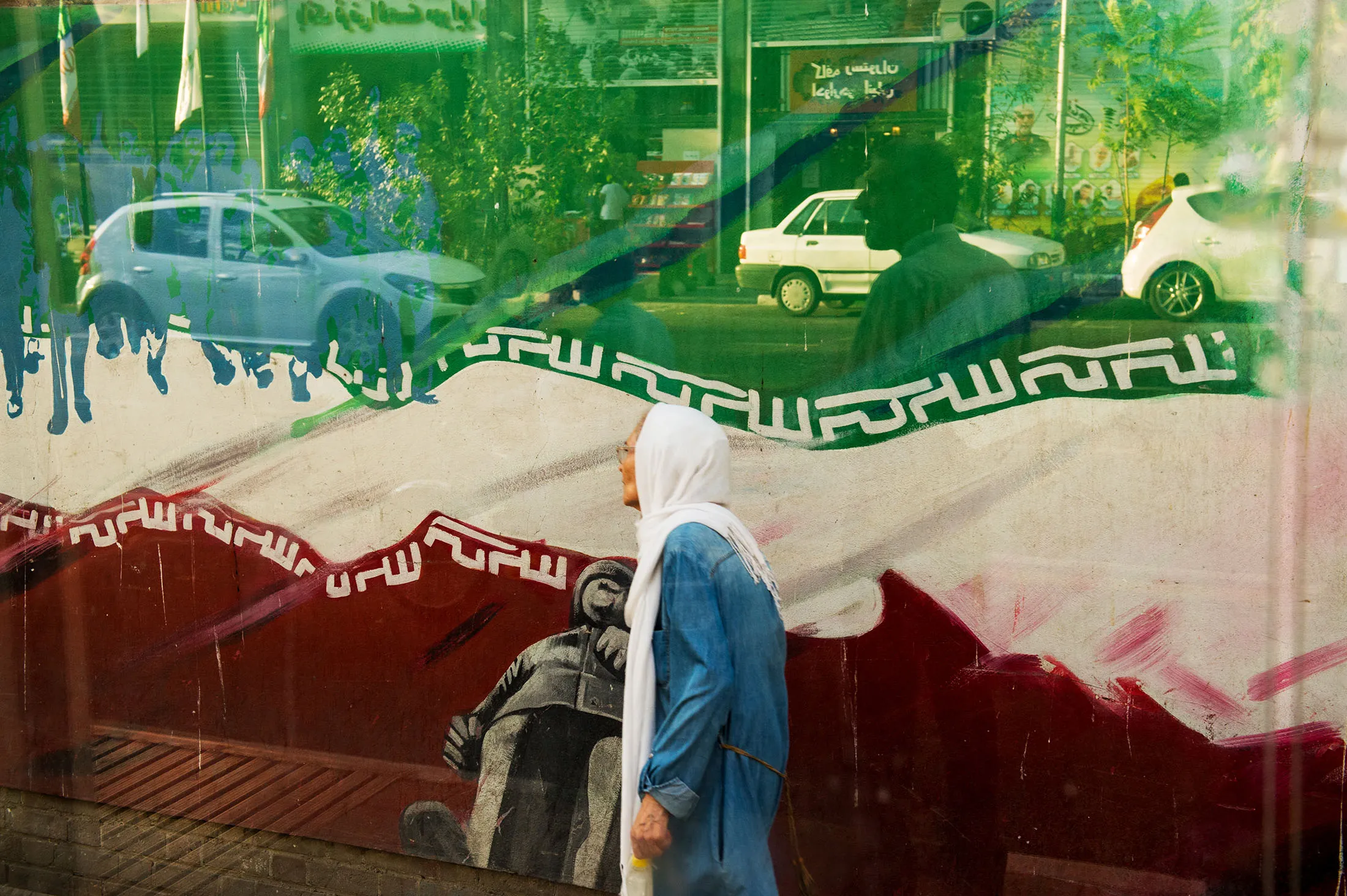 A&nbsp;woman walks past a political wall mural outside the former U.S. embassy in Tehran, Iran, on&nbsp;Aug. 5, 2018.&nbsp;