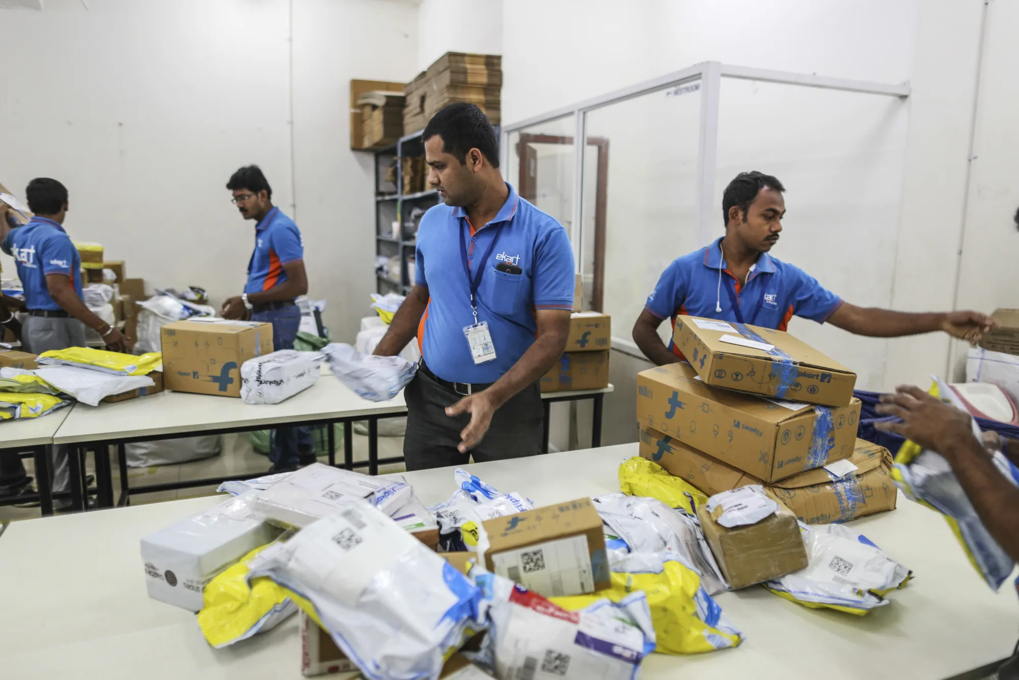 Workers sort packages at a Flipkart&nbsp;office&nbsp;in&nbsp;Bengaluru, India.