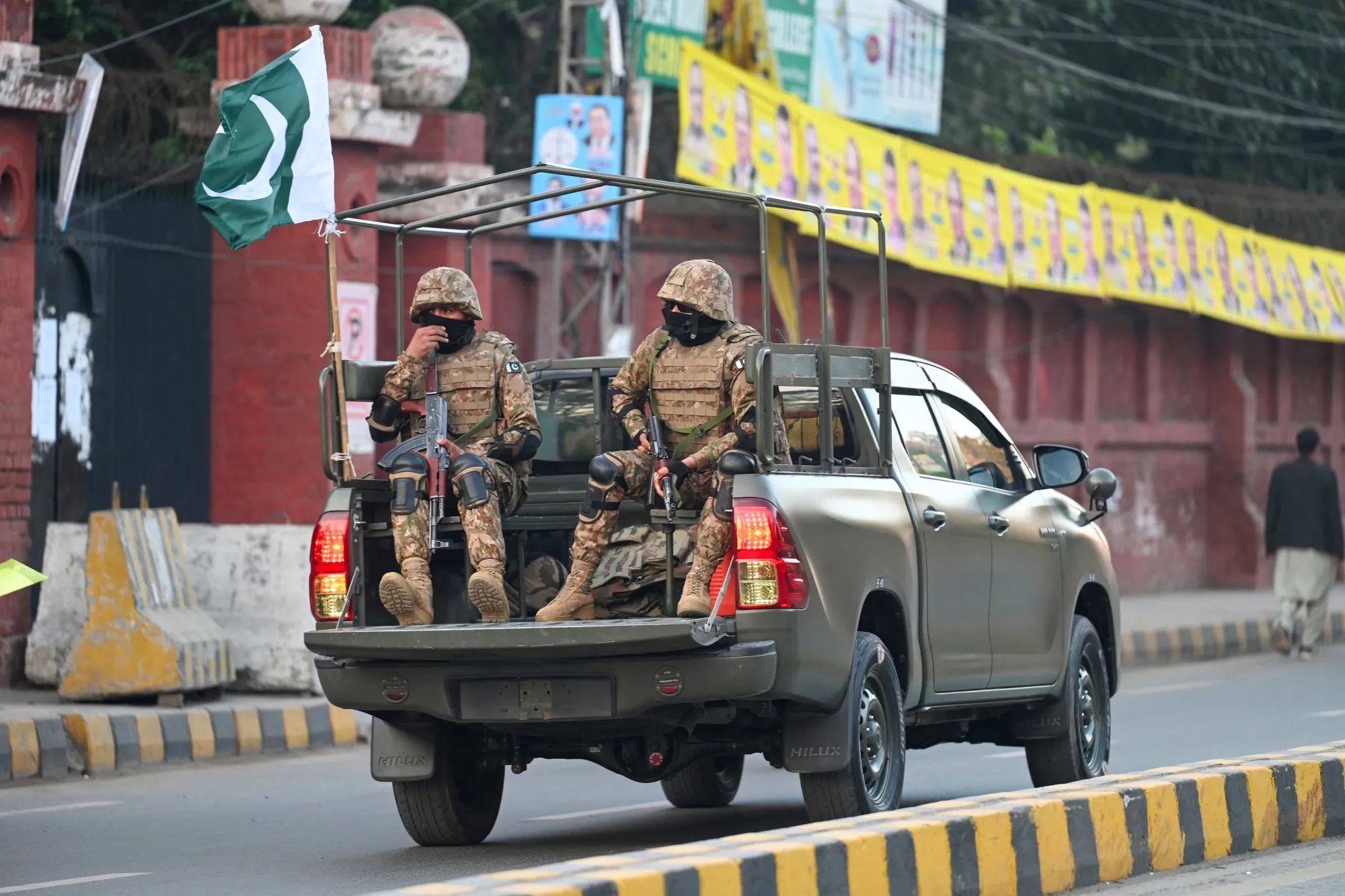 Military troops patrol near a polling station during Pakistan’s national elections in Lahore on Feb. 8.