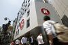 Pedestrians walk past the Rakuten Cafe, operated by Rakuten Inc., in Tokyo.