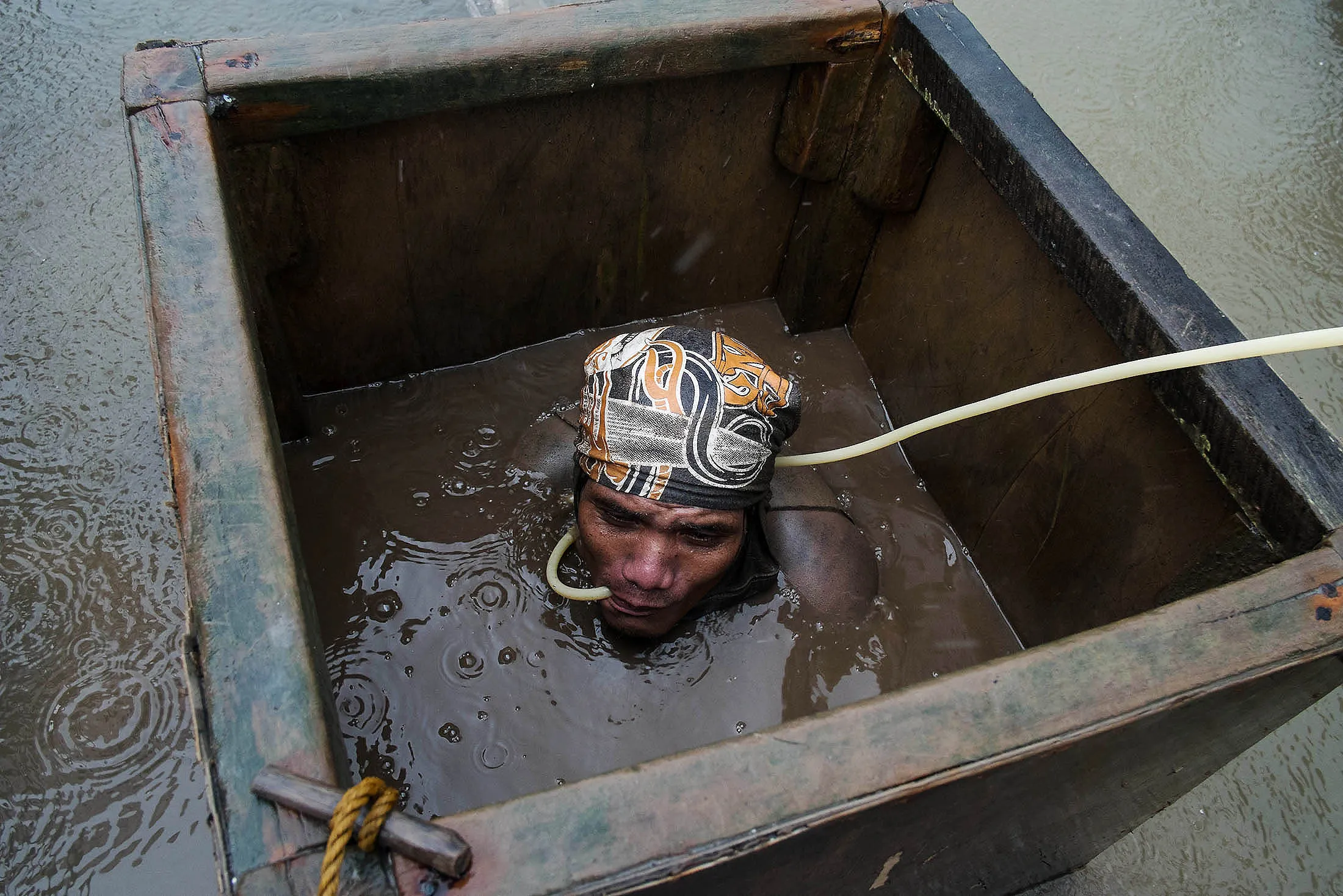 An miner prepares to dive underwater in Santa Milagrosa, Philippines.
