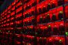Illuminated racks of application-specific integrated circuit (ASIC) mining devices and power units at the BitCluster cryptocurrency mining farm in Norilsk, Russia, on Sunday, Dec. 20, 2020. Norilsk may soon be famous for a different type of mining — it now hosts the Arctic's first crypto farm for producing new Bitcoins.