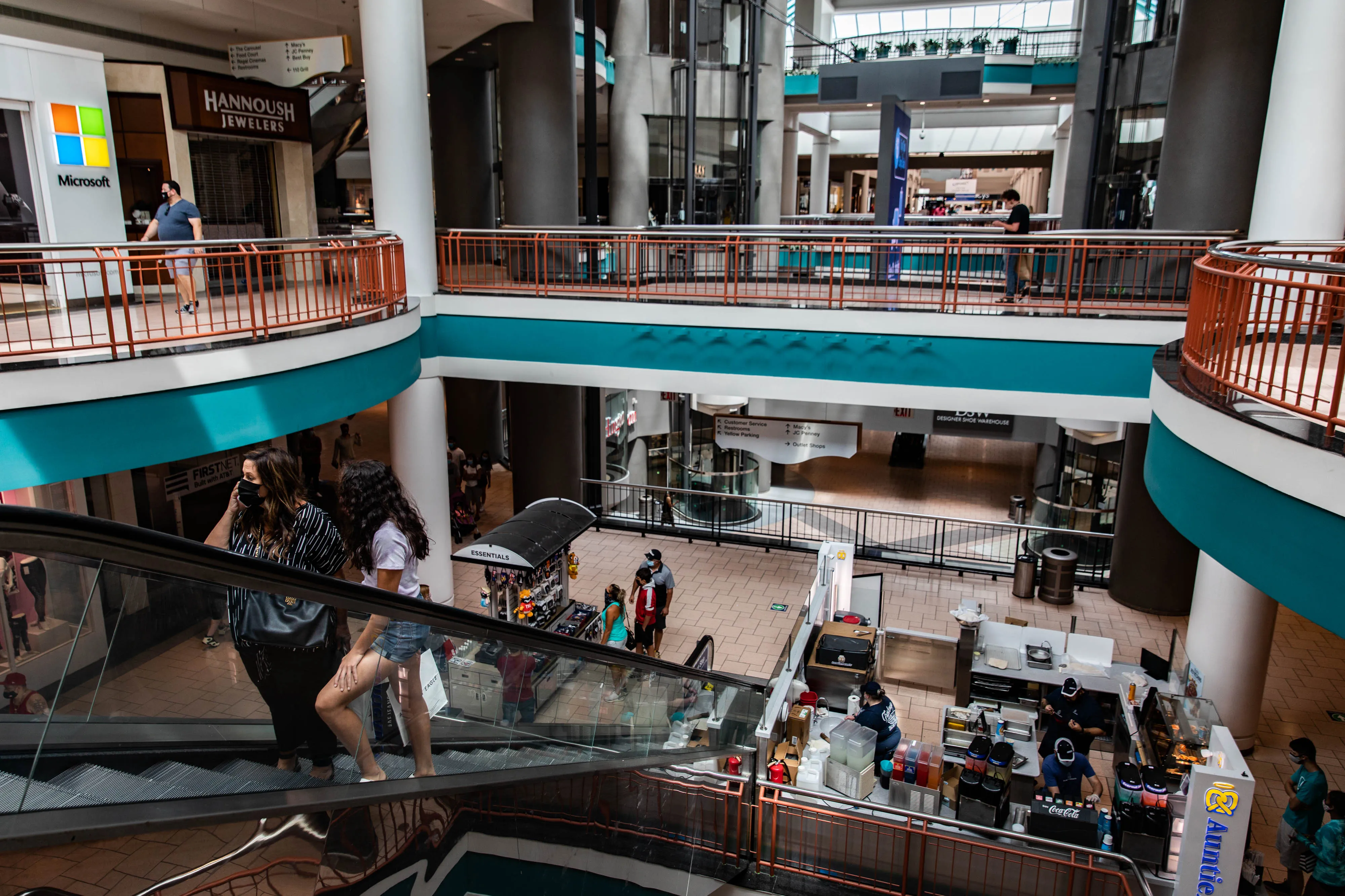 Shoppers ride up an escalator at a mall in Syracuse, New York on July 10.