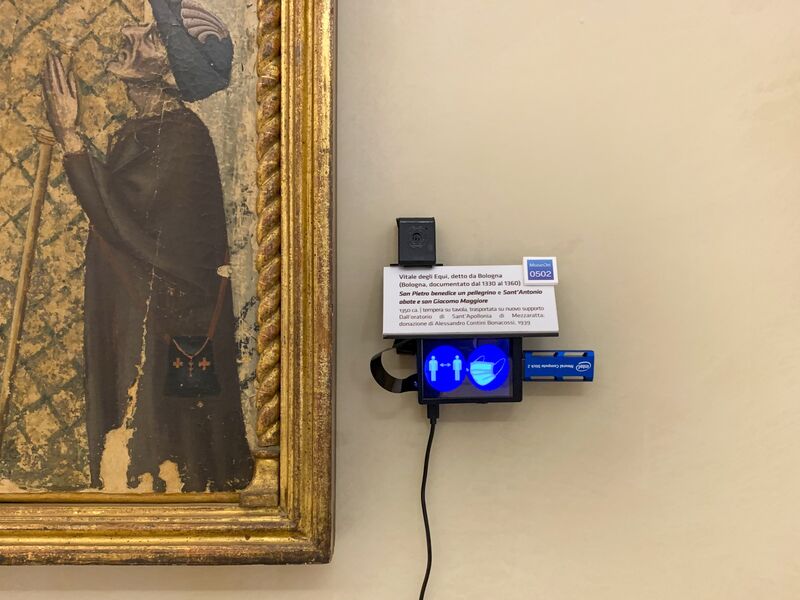A ShareArt camera next to a painting in the Istituzione Bologna Musei. 