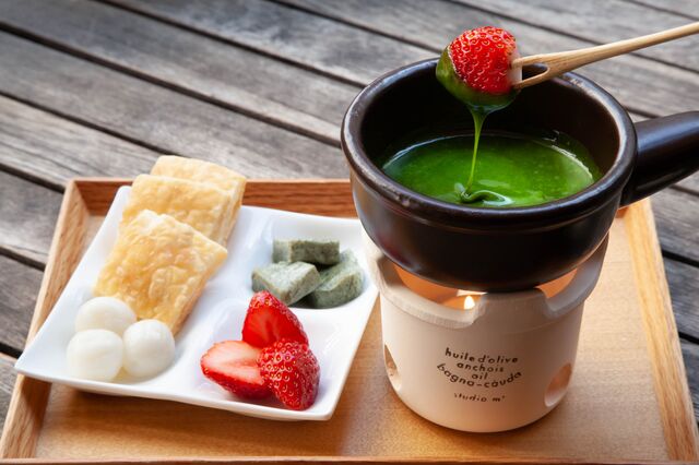 strawberries, matcha fondue, sugar pastries on tray