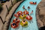 People ride on tubes at a water park in Concord, California on June 17.