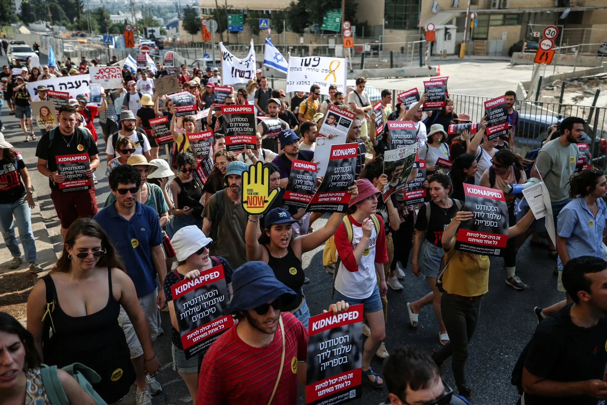 Israeli students hold images of kidnapped Israelis and anti-war placards while&nbsp;demonstrating&nbsp;outside the Knesset in Jerusalem on June 13.