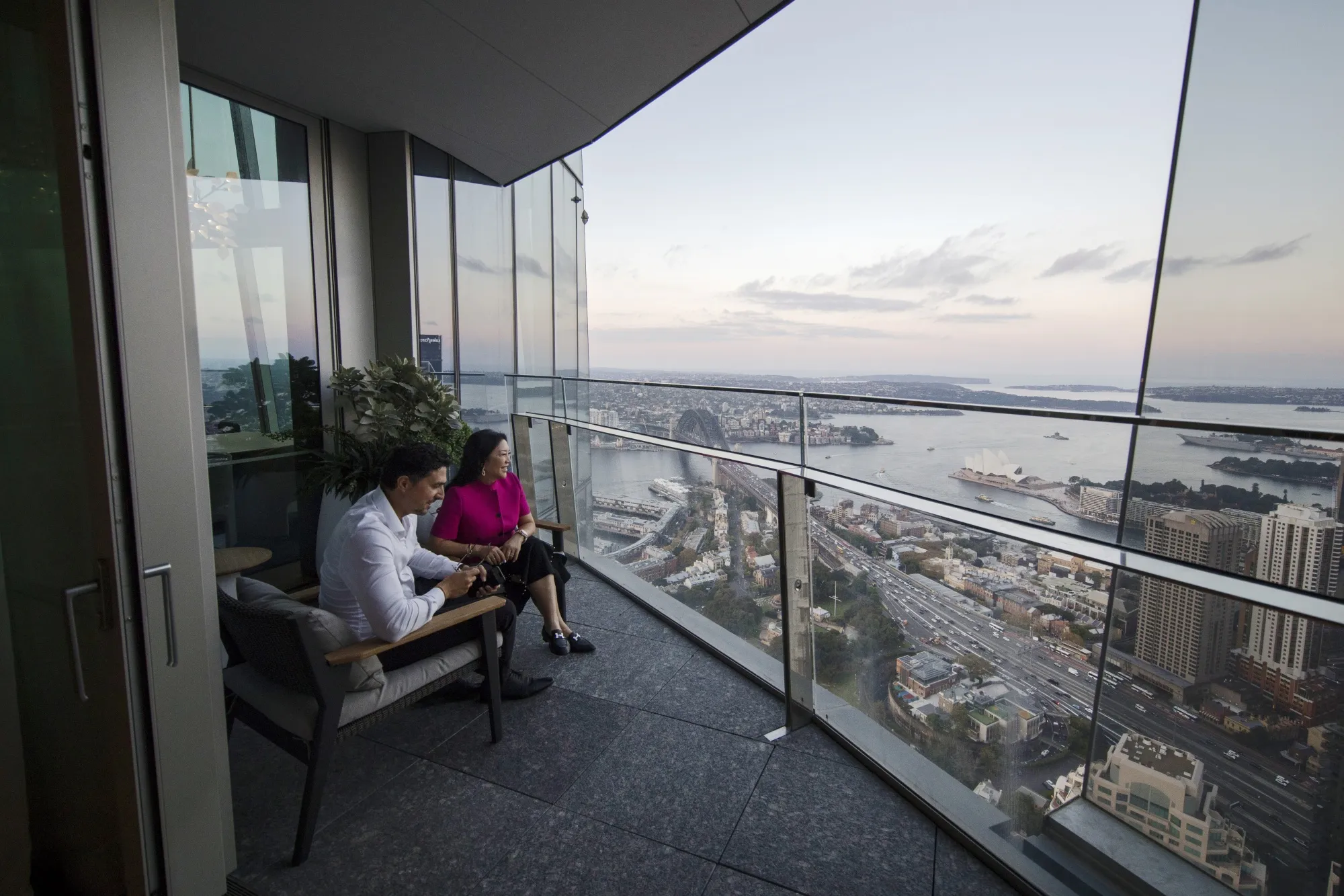 Monika Tu with her husband on a balcony in the penthouse at One Barangaroo Crown residences in Sydney.