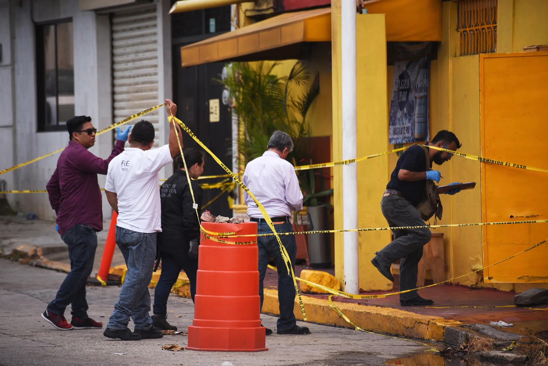 Experts work a scene two days after 28 people were killed in a shooting in Coatzacoalcos, Veracruz State, Mexico, on Aug. 29