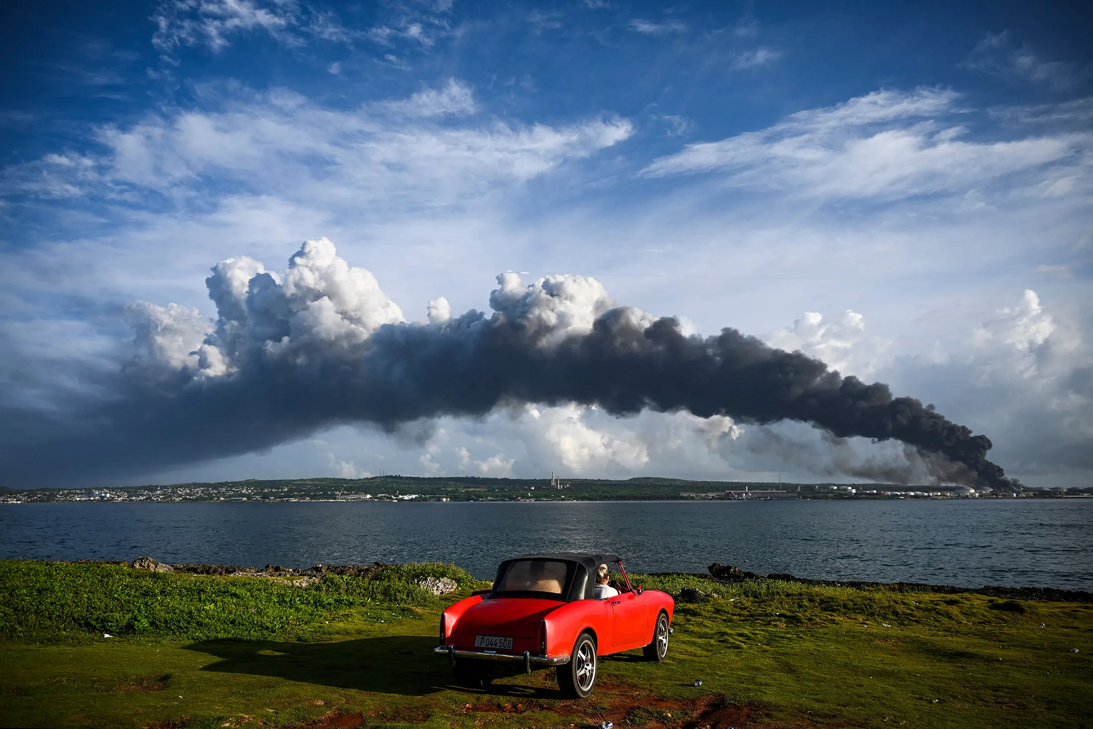 TOPSHOT - Black smoke&nbsp;from a fuel depot fire is seen near Matanzas Bay, Cuba, on Aug. 7.