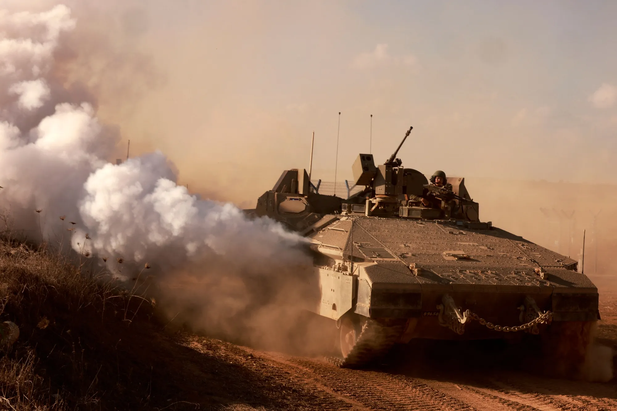 A military&nbsp;armored personnel carrier drives on a road near&nbsp;the border on Oct. 15.