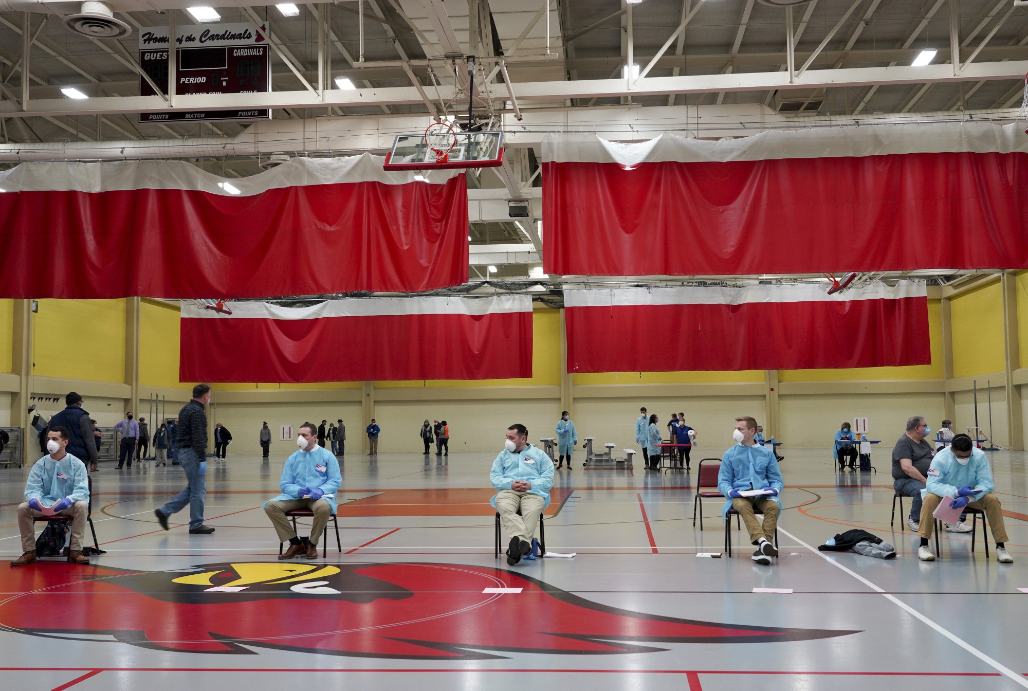 Election volunteers wearing protective gear sit at a distance at a polling station in Milwaukee, Wisconsin, on April 7.