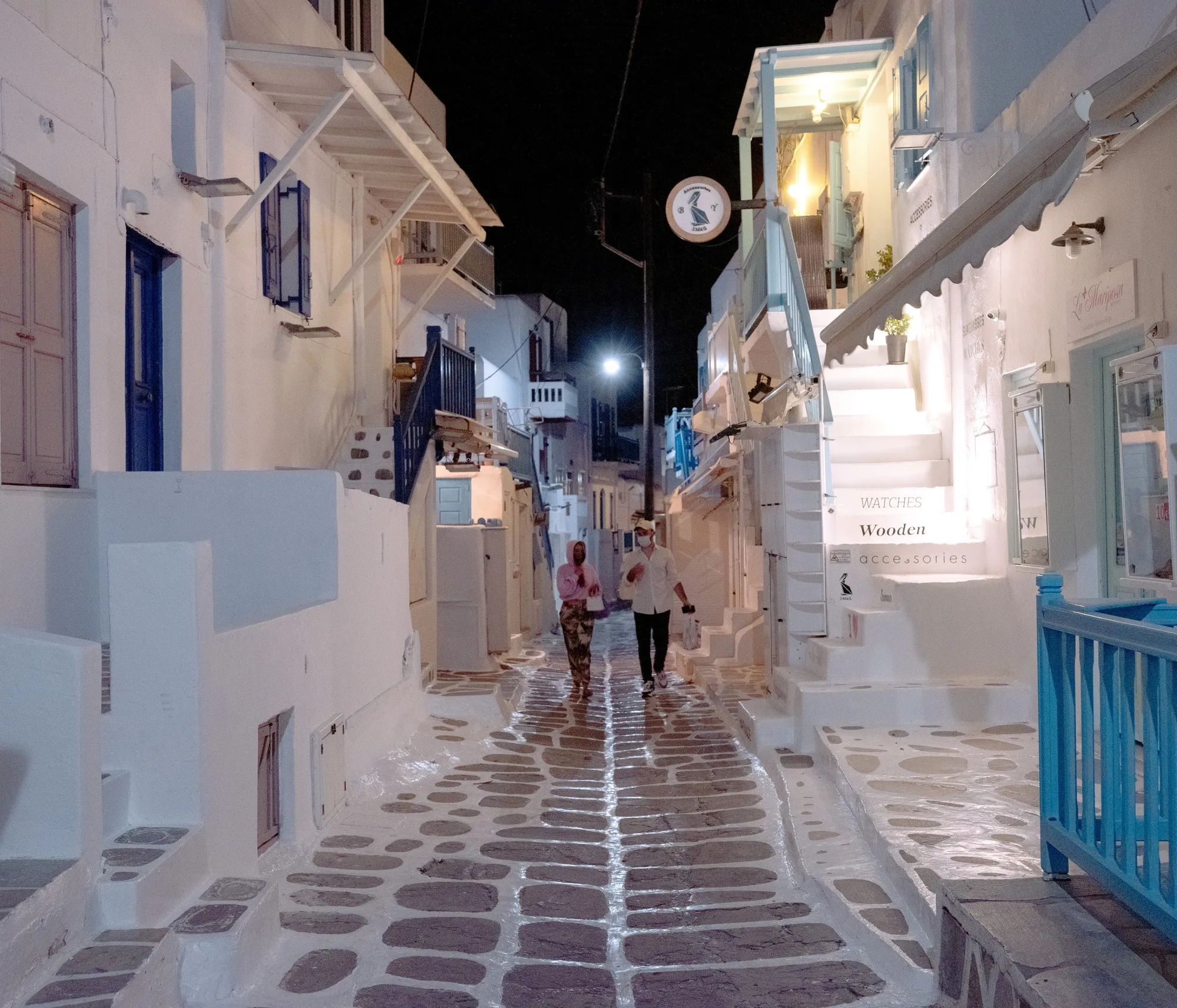Pedestrians walk along an empty street ahead of the return of tourists in Mykonos, Greece, on May 9.