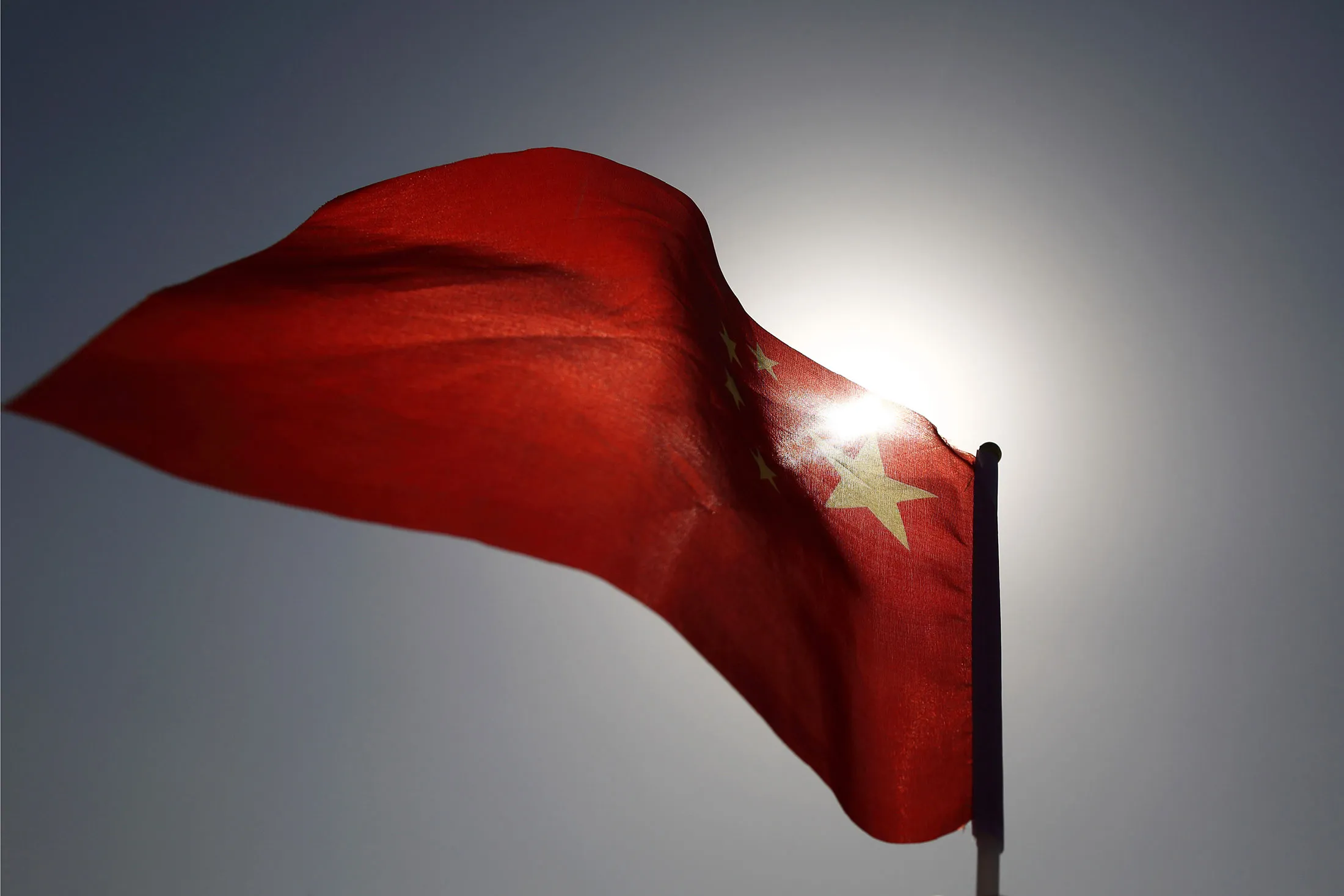 A Chinese national flag flies in Beijing, China, on Monday, March 2, 2015. China's annual meeting of the National People's Congress, which begins March 5 in Beijing, is expected to set government policies for the year on issues ranging from economic growth to military spending and pollution.
