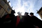 A group of graduates gather at Oxford University in Oxford, England, which topped Times Higher Education World University Rankings.