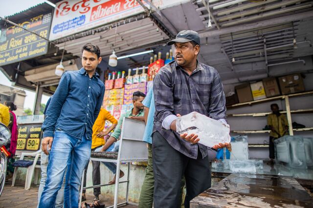 A man buys slabs of ice from shop on a hot summer day in Ahemdabad, Gujarat, India, on Friday, May 5, 2023. Photographer: Prashanth Vishwanathan/Bloomberg