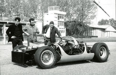 Tom Meade (center, standing), a car designer from California, conceived the car.