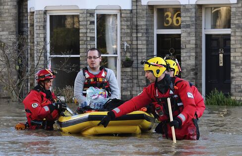 Rescuers assist members of the public as they are evacuated from the Queens Hotel in York city centre Dec. 27, 2015.